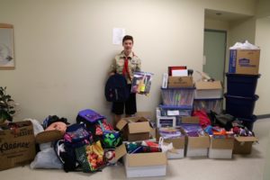 Kaulani, aspiring Eagle Scout, with donation of school supplies and items for school-aged RAIS clients.