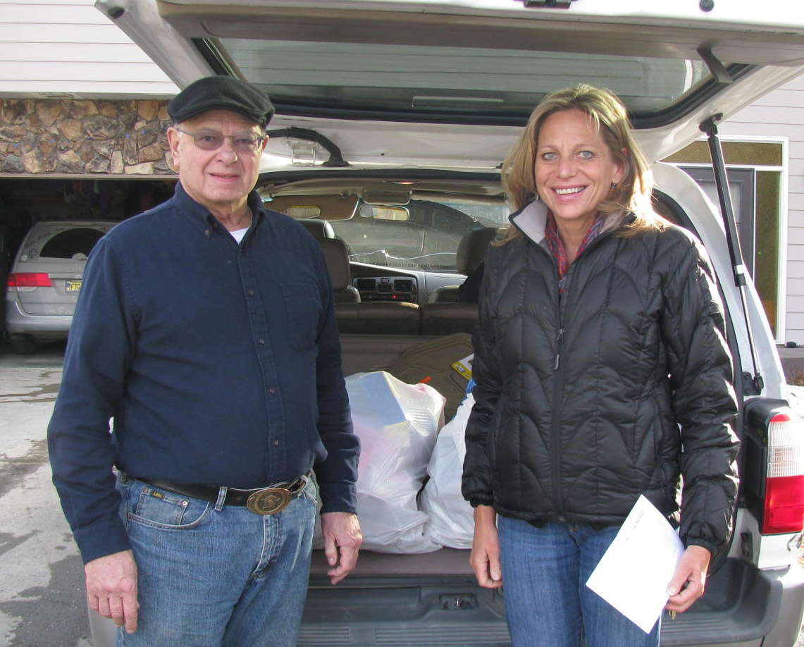 Bob McMorrow Sr. with Tricia Teasley of CSS delivering gloves for Brother Francis Shelter.