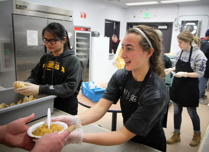 Volunteers from the University of Minnesota serving dinner at Brother Francis Shelter.